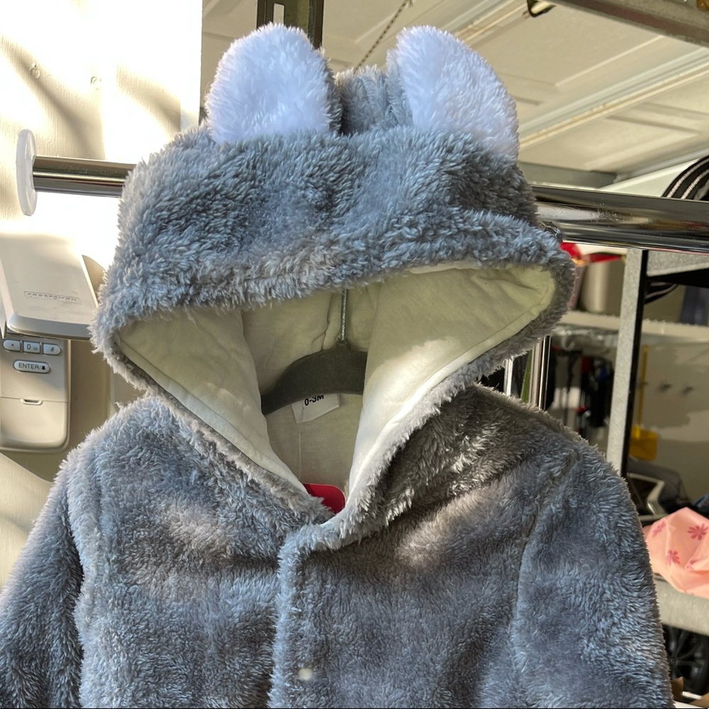 Adorable one piece fluffy baby jacket.Variety of sizes including in soft pink.